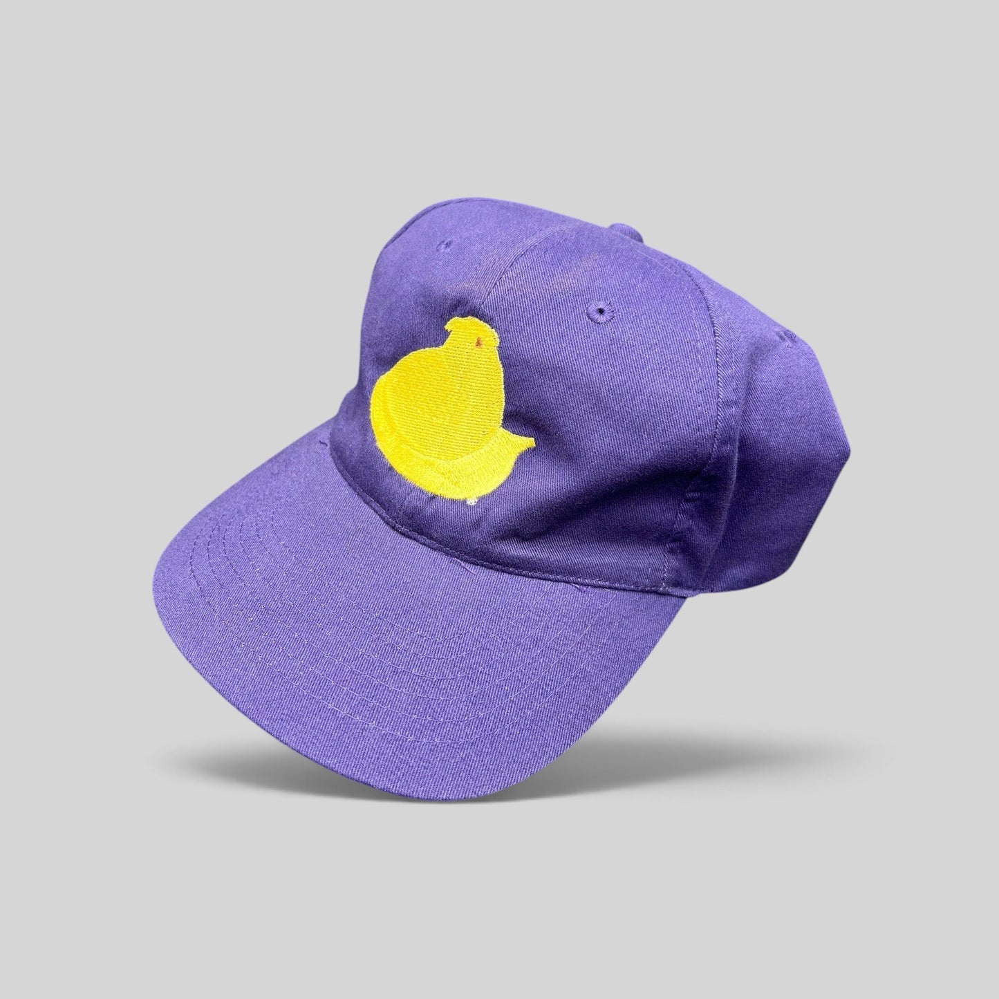 Raree Finds purple strapback cap featuring a yellow embroidered Marshmallow Peeps chick on the front