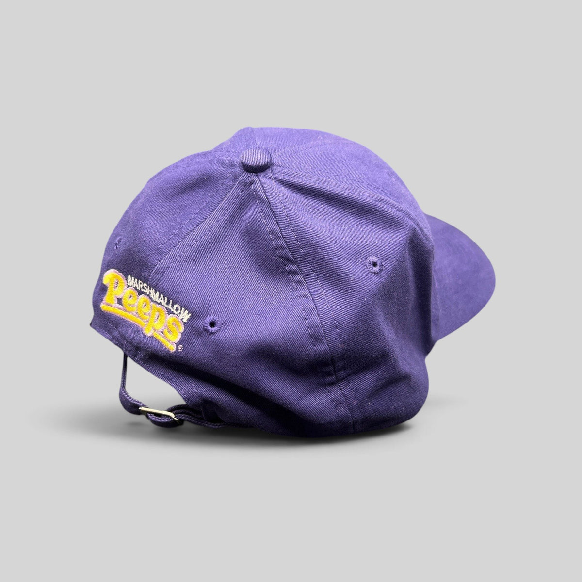Raree Finds purple strapback cap featuring yellow Marshmallow Peeps embroidery on the back, cotton-poly blend.