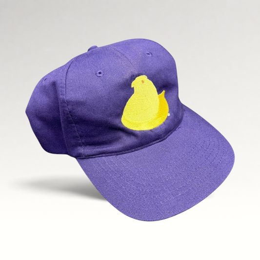 Raree Finds purple strapback cap featuring a yellow embroidered Marshmallow Peeps chick on the front panel.