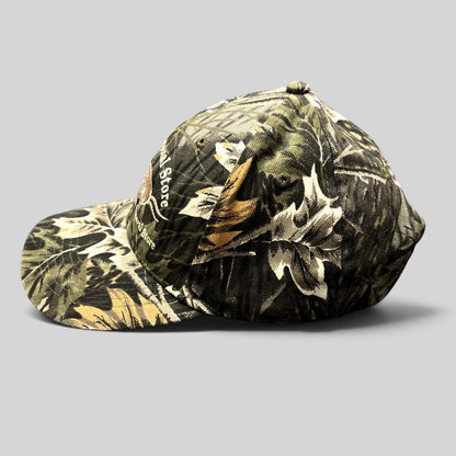 Raree Finds Putney General Store woodland camouflage strapback hat with embroidered Vermont logo and curved brim.