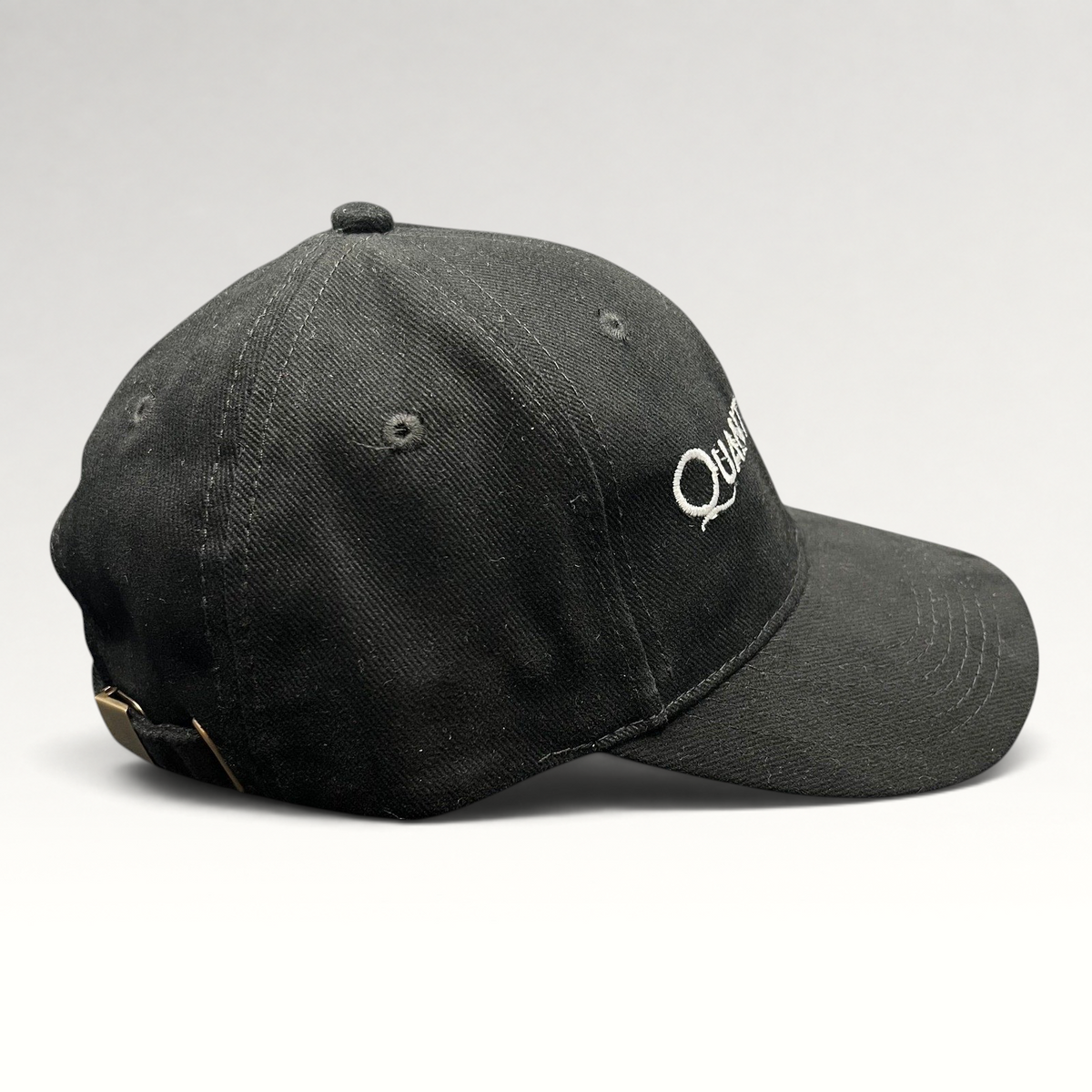 Raree Finds black Quantum of Solace 007 strapback hat with white embroidery and brass buckle side view