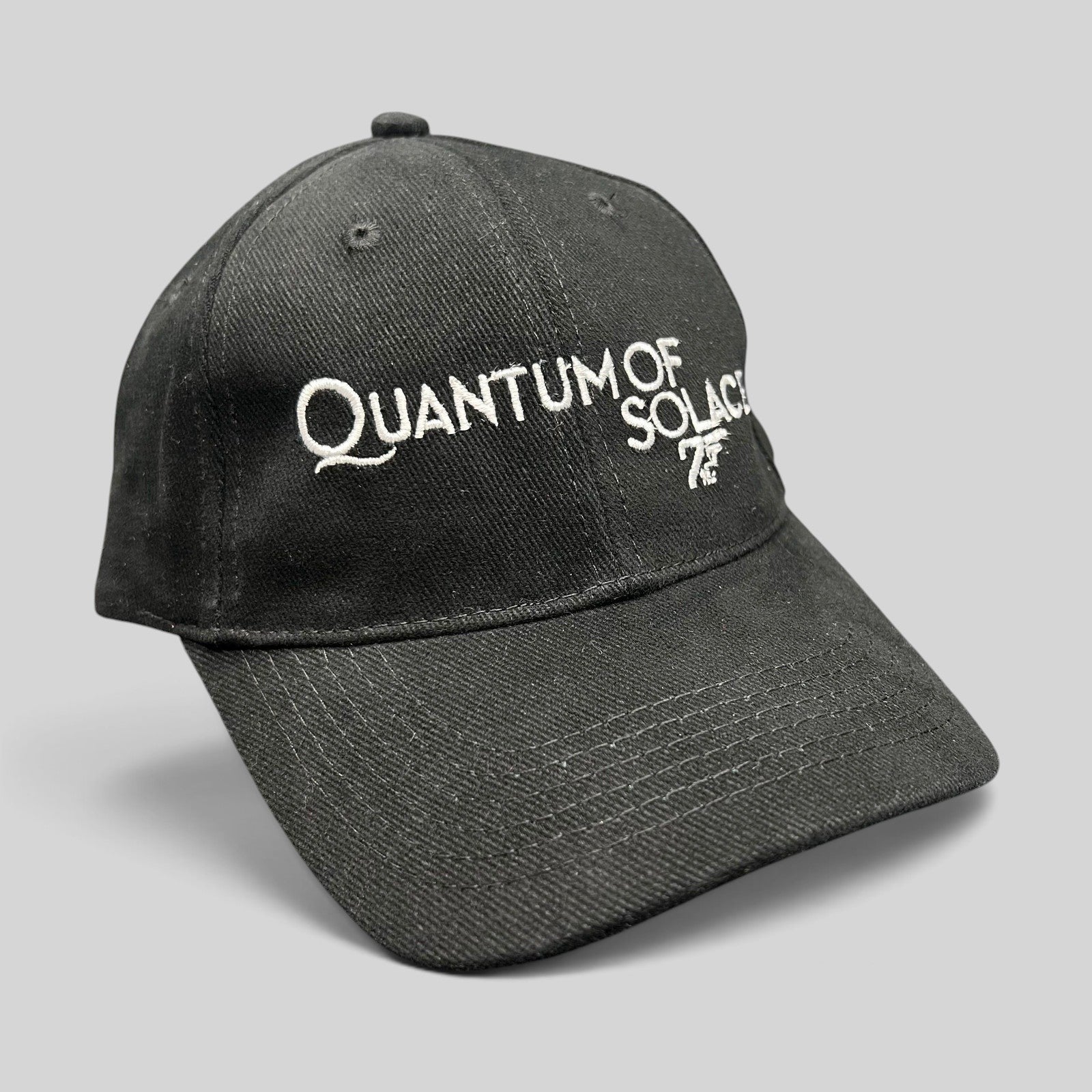 Raree Finds black Quantum of Solace 007 promotional strapback hat with white embroidered movie title and gun logo