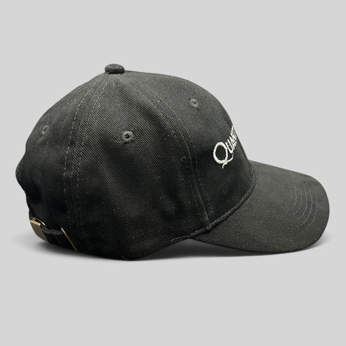 Raree Finds black Quantum of Solace 007 strapback hat with white embroidery and brass buckle side view