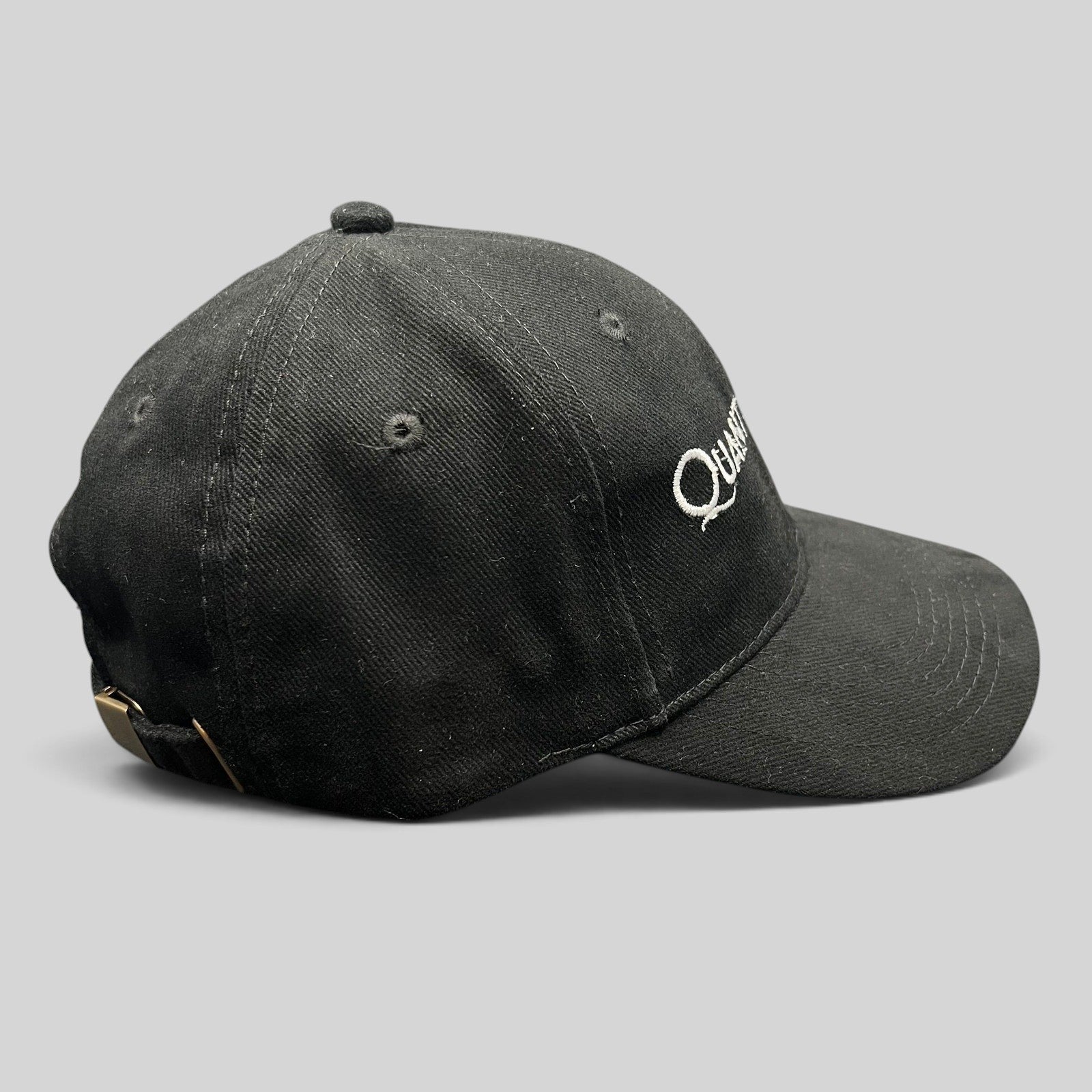 Raree Finds black Quantum of Solace 007 strapback hat with white embroidery and brass buckle side view