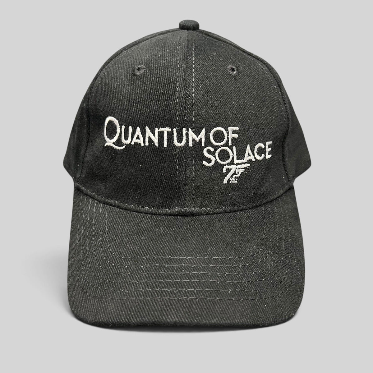 Raree Finds black Quantum of Solace strapback hat with white 007 gun logo embroidery and curved bill