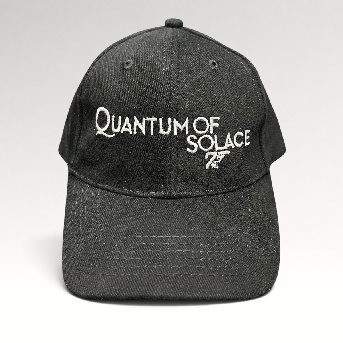 Raree Finds black Quantum of Solace strapback hat with white 007 gun logo embroidery and curved bill