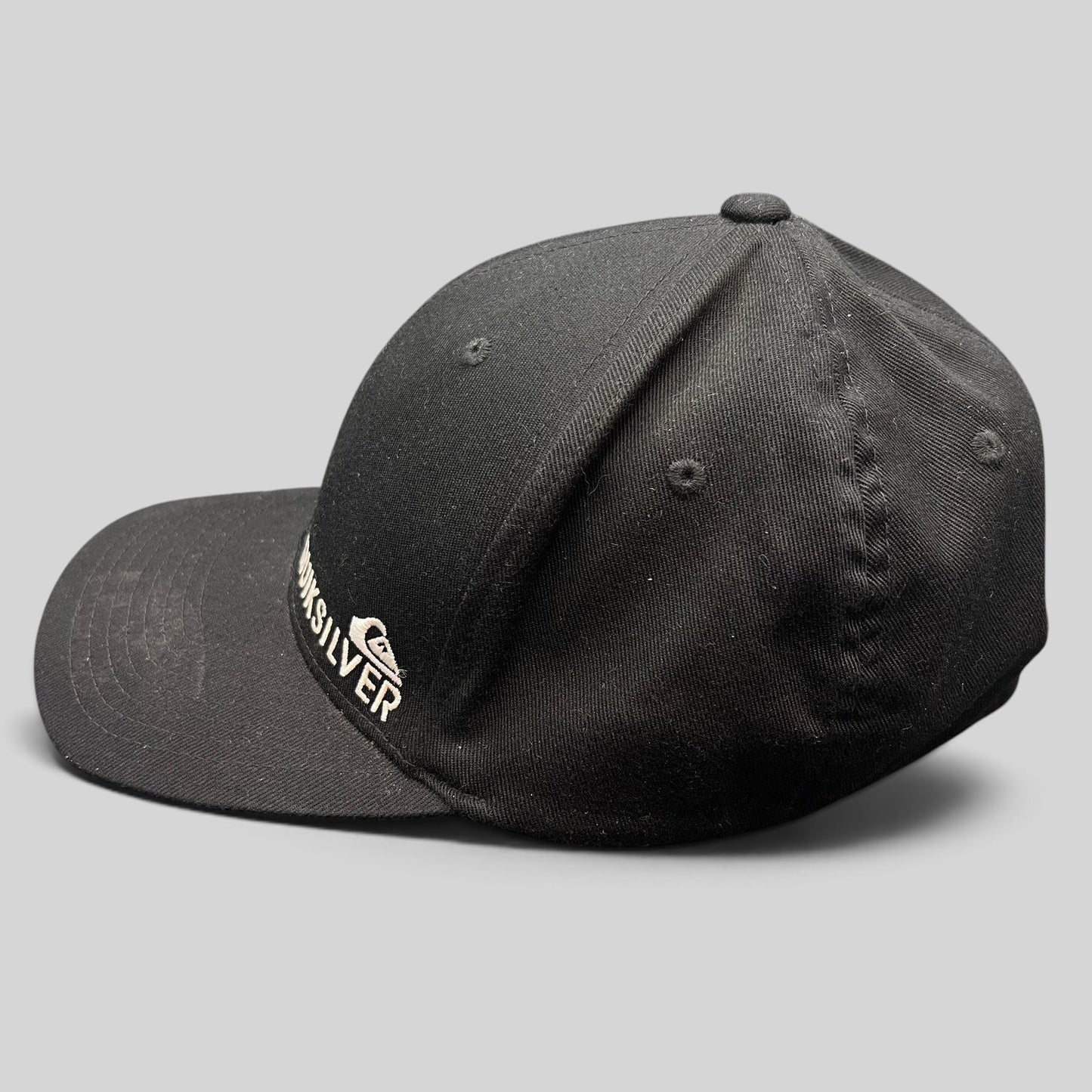 Raree Finds black Quiksilver Flexfit cap with white embroidered mountain and wave logo on a structured crown