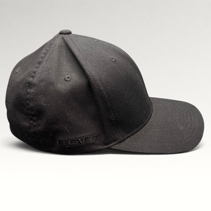 Raree Finds black Quiksilver Flexfit cap with a structured crown and curved bill, side view.