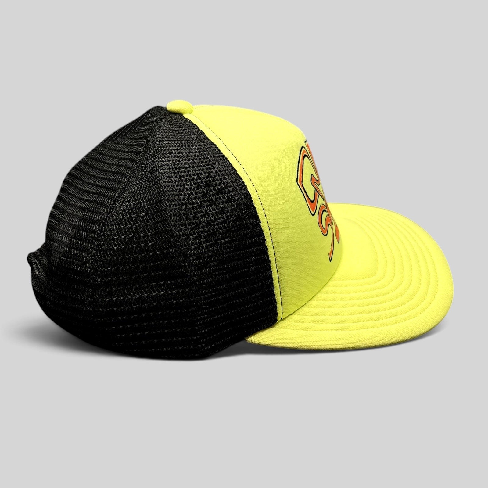 Raree Finds Quiksilver neon yellow and black trucker hat with mesh back and embroidered logo, side profile view.