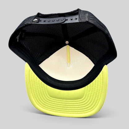 Raree Finds Quiksilver trucker hat interior showing neon yellow brim, black mesh back, and adjustable snapback closure.