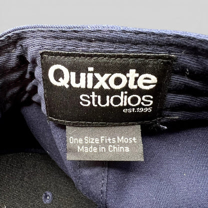 Raree Finds Quixote Studios navy blue snapback hat interior brand label with white text and made in China tag
