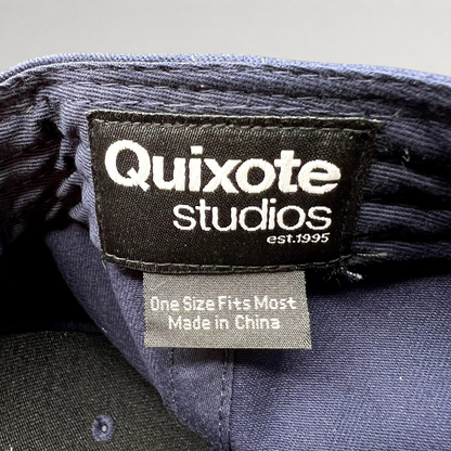 Raree Finds Quixote Studios navy blue snapback hat interior brand label with white text and made in China tag