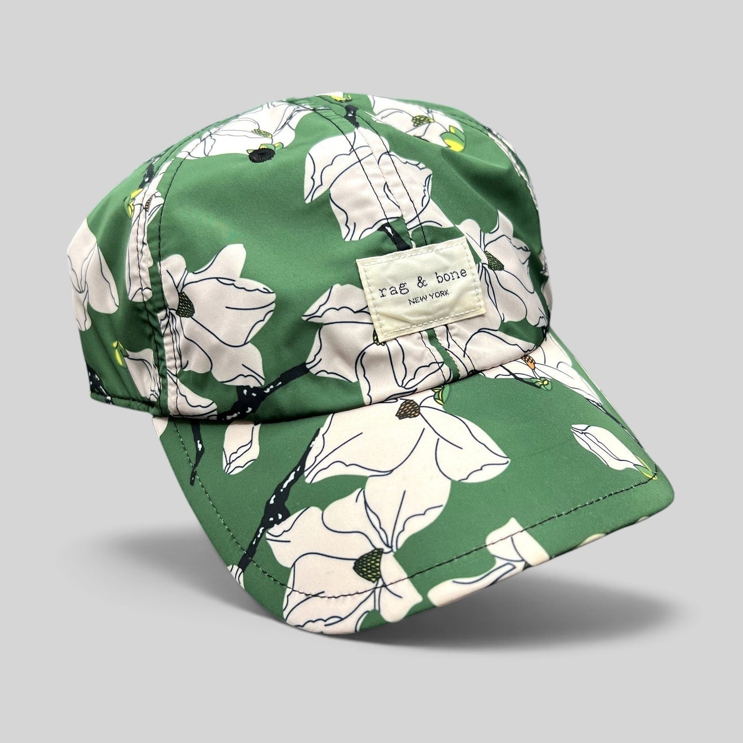 Raree Finds Rag & Bone New York green magnolia floral print strapback cap with a curved brim and brand patch.