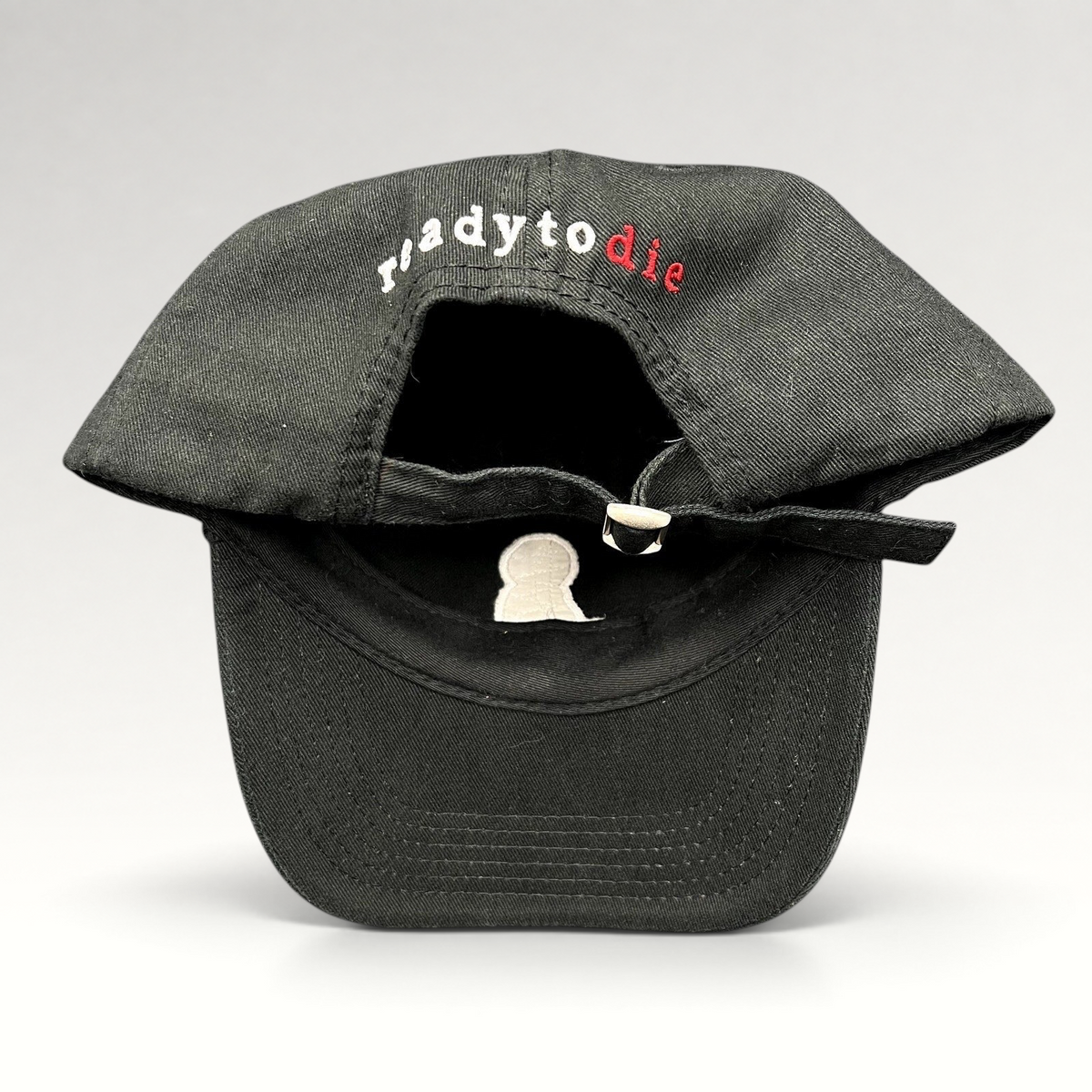 Raree Finds black strapback hat featuring Ready To Die embroidered text in white and red on the back with metal slide