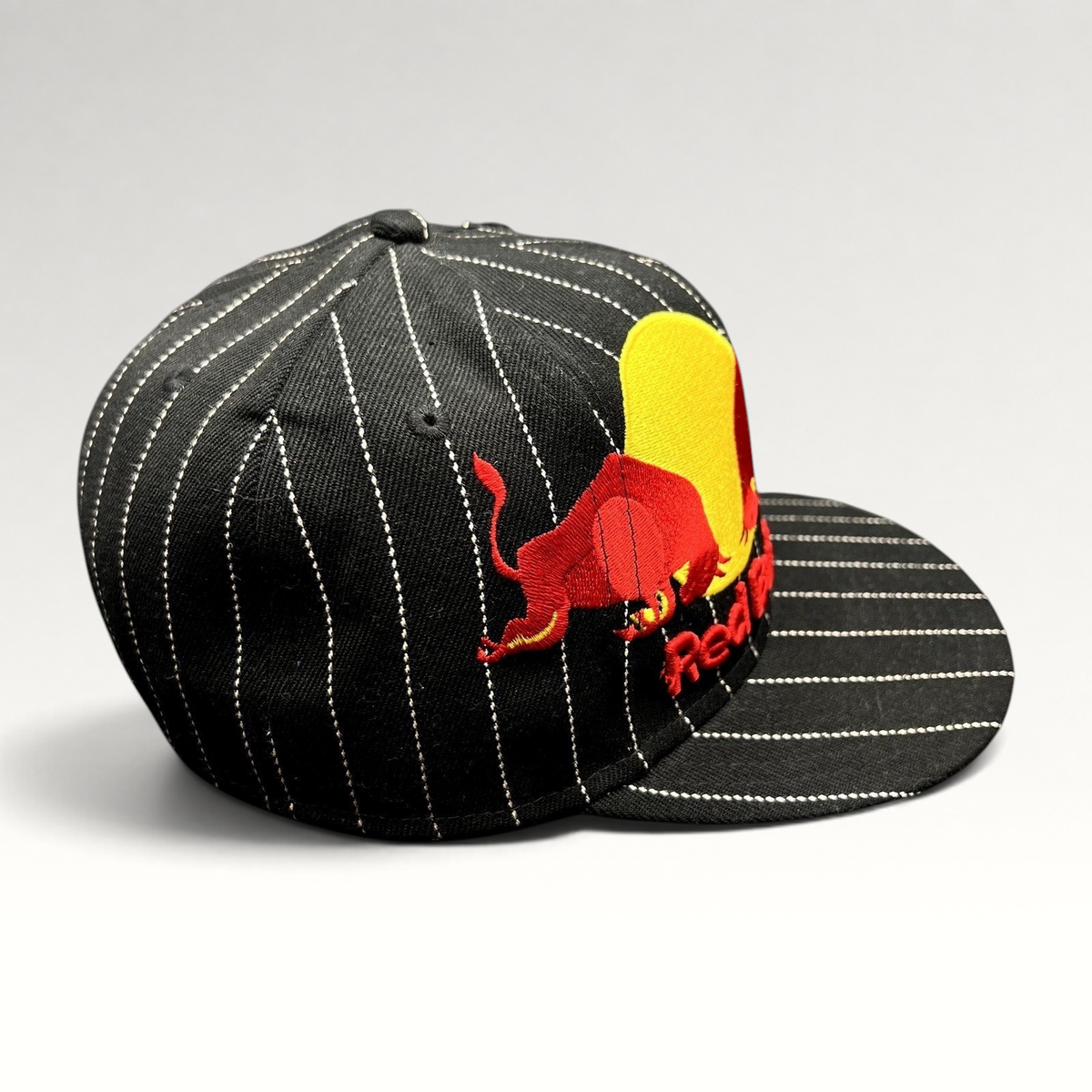 Raree Finds black wool-blend New Era 59FIFTY fitted hat with white pinstripes and embroidered Red Bull logo