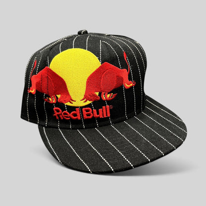 Raree Finds black and white pinstripe New Era 59FIFTY fitted hat with embroidered Red Bull logo and flat brim.