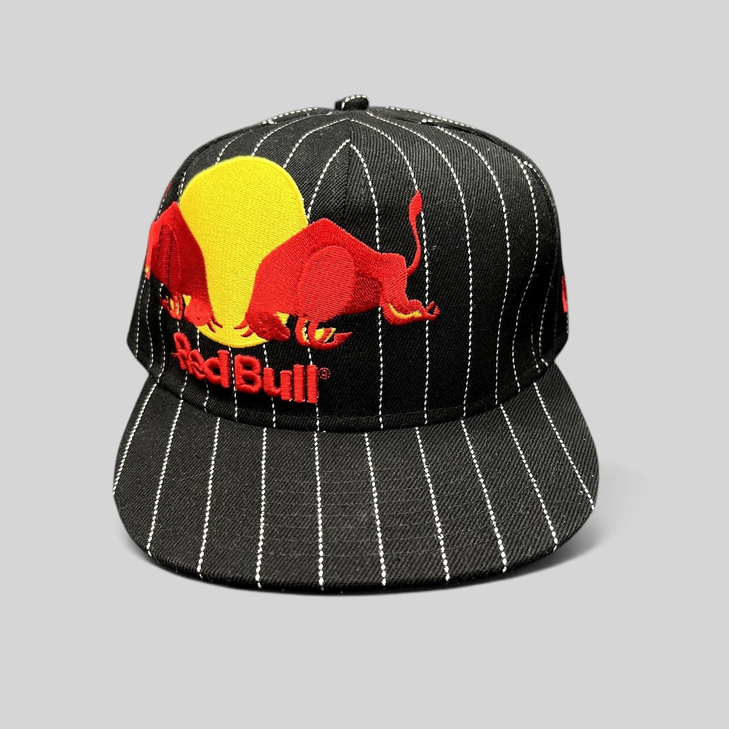 Raree Finds black and white pinstripe New Era 59FIFTY fitted hat with embroidered Red Bull logo and flat brim