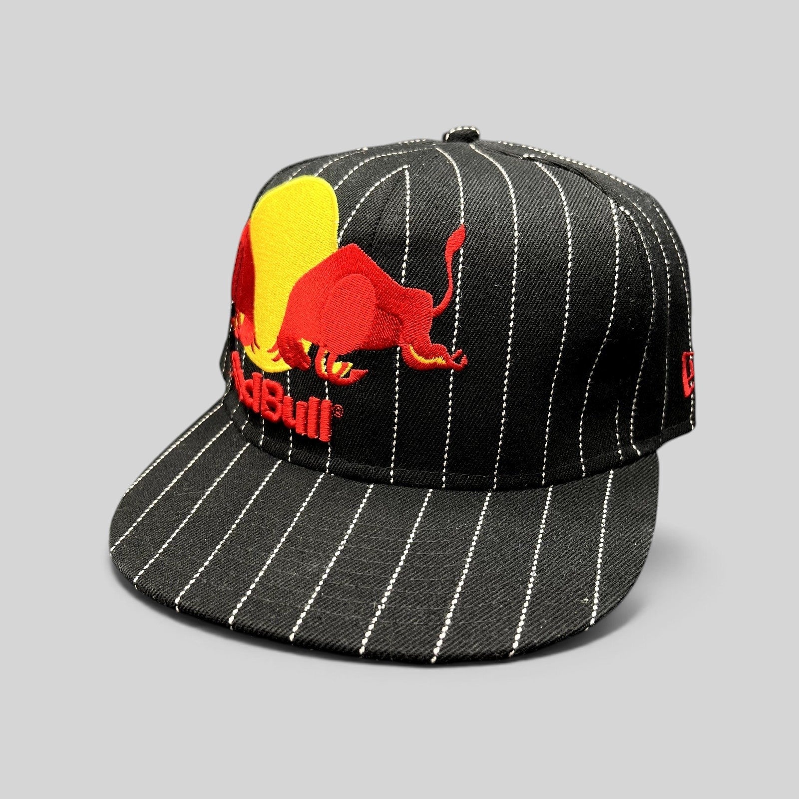 Raree Finds New Era 59FIFTY black fitted hat with white pinstripes and embroidered Red Bull logo on the front.