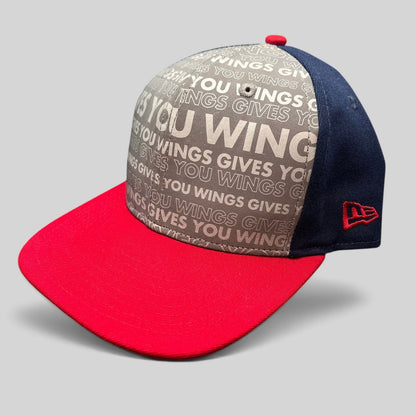 Raree Finds New Era Red Bull snapback hat with grey slogan print, navy side panels, and a bright red brim.