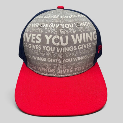 Raree Finds Red Bull Gives You Wings snapback hat by New Era featuring a grey slogan print, navy panels, and red brim.