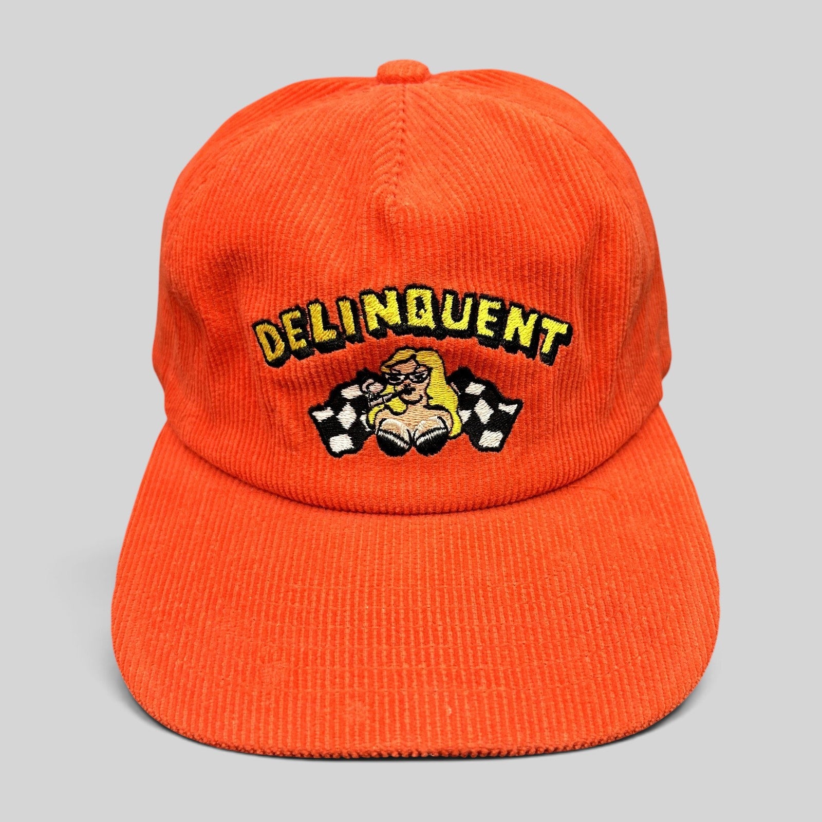Raree Finds red corduroy snapback hat featuring an embroidered Delinquent pinup girl and checkered racing flags.