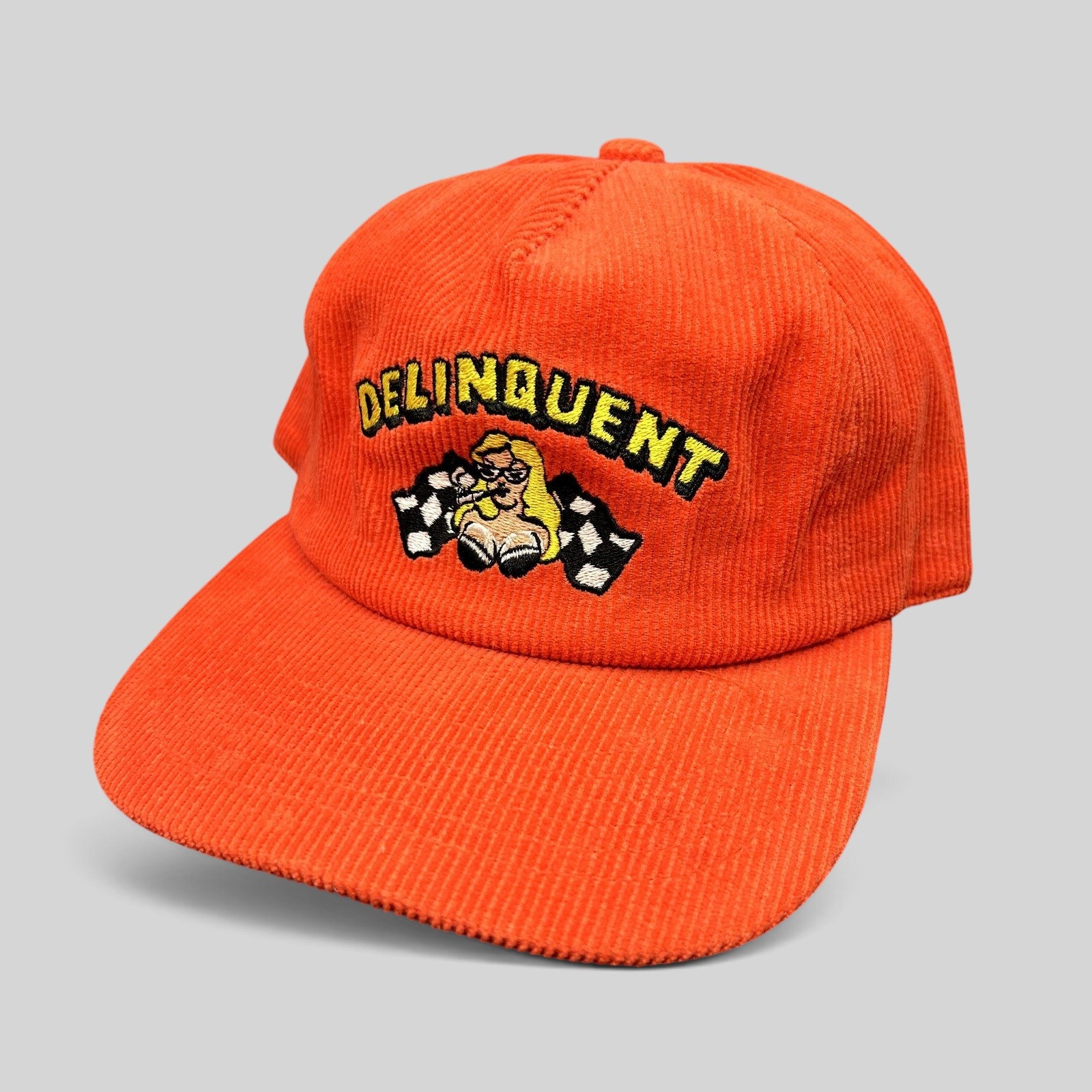Raree Finds Delinquent Bros red corduroy snapback hat with embroidered pinup girl and checkered flag racing graphic.