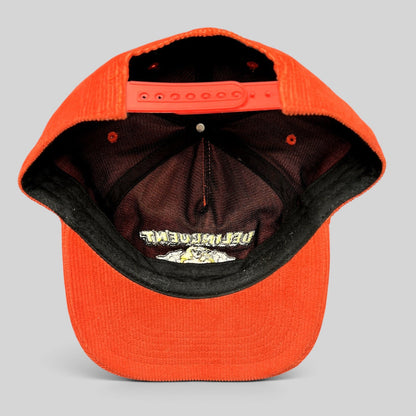 Raree Finds Delinquent Bros red corduroy snapback cap showing the interior crown, adjustable strap, and embroidery.