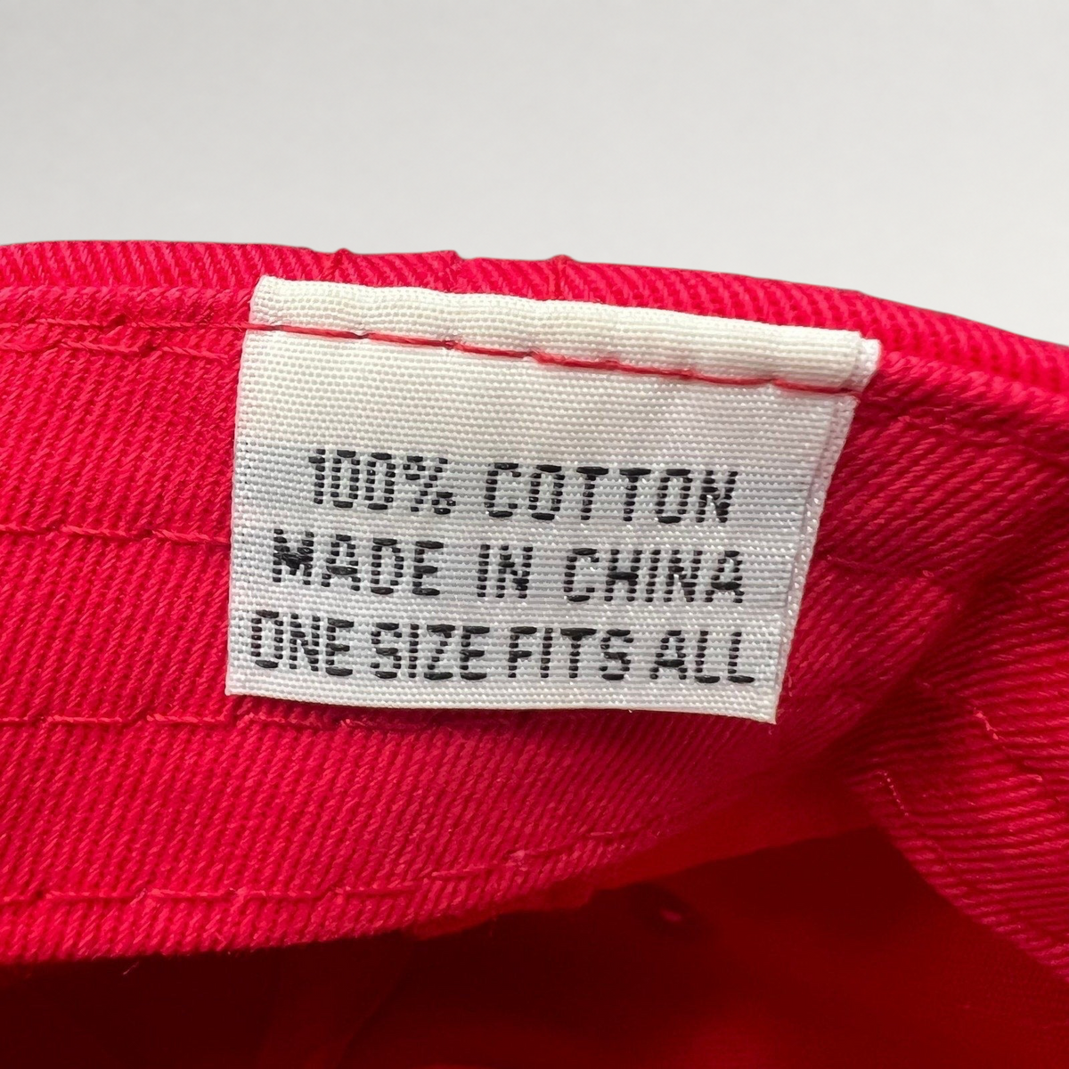 Raree Finds vintage red cotton hat interior care label showing 100 percent cotton and one size fits all text