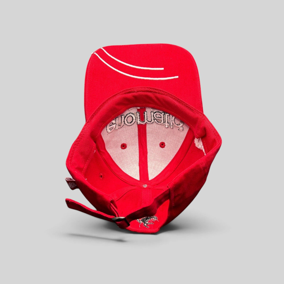 Raree Finds red Enomatic Ferrari racing hat showing interior branding and adjustable strapback closure