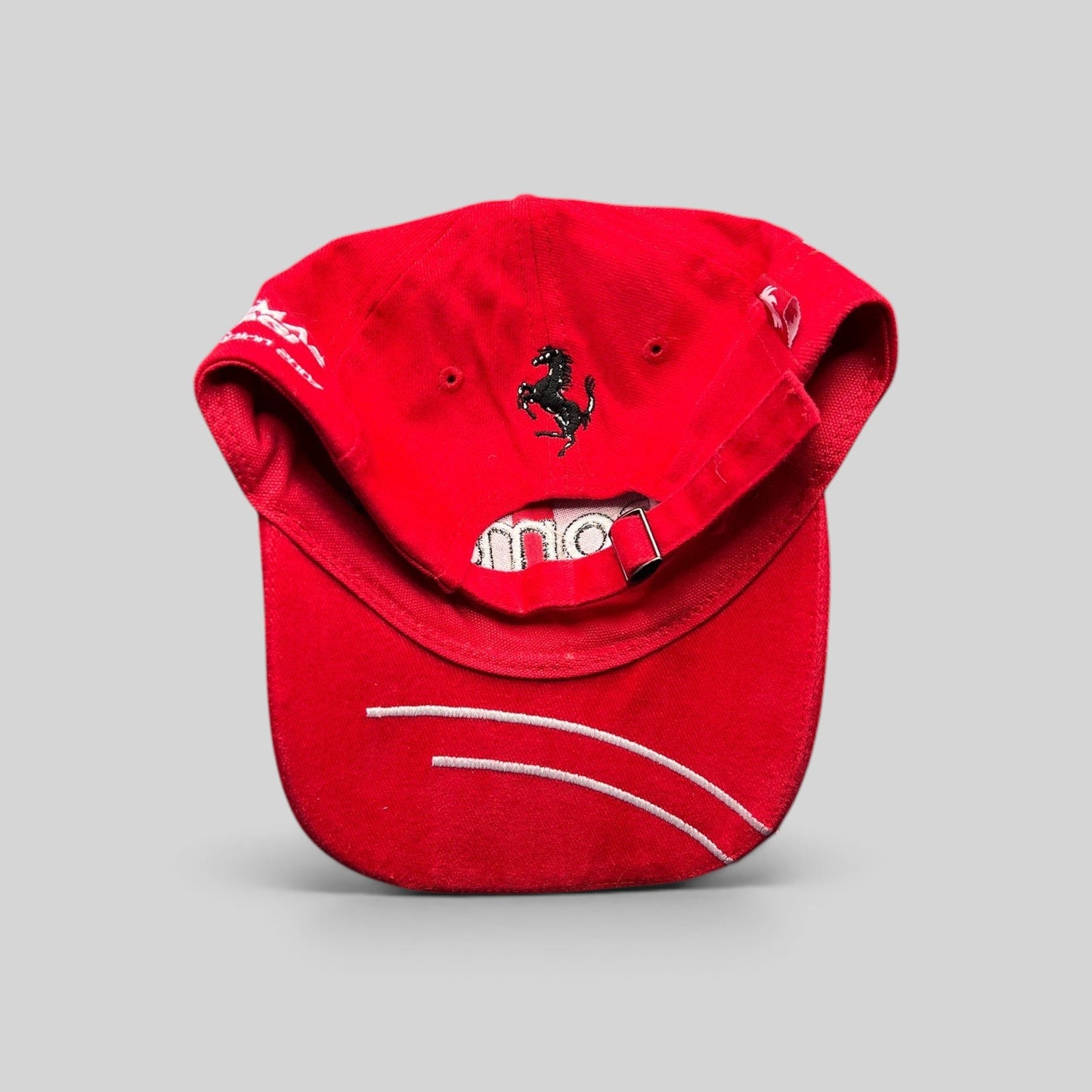 Raree Finds red Enomatic Ferrari racing hat with black prancing horse embroidery on the back and white brim stitching