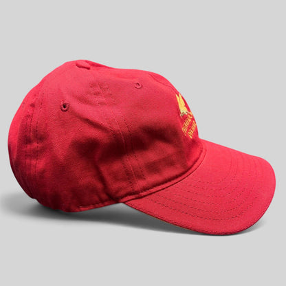 Raree Finds red cotton twill strapback golf cap featuring The Meadows Del Mar golden flower logo embroidery