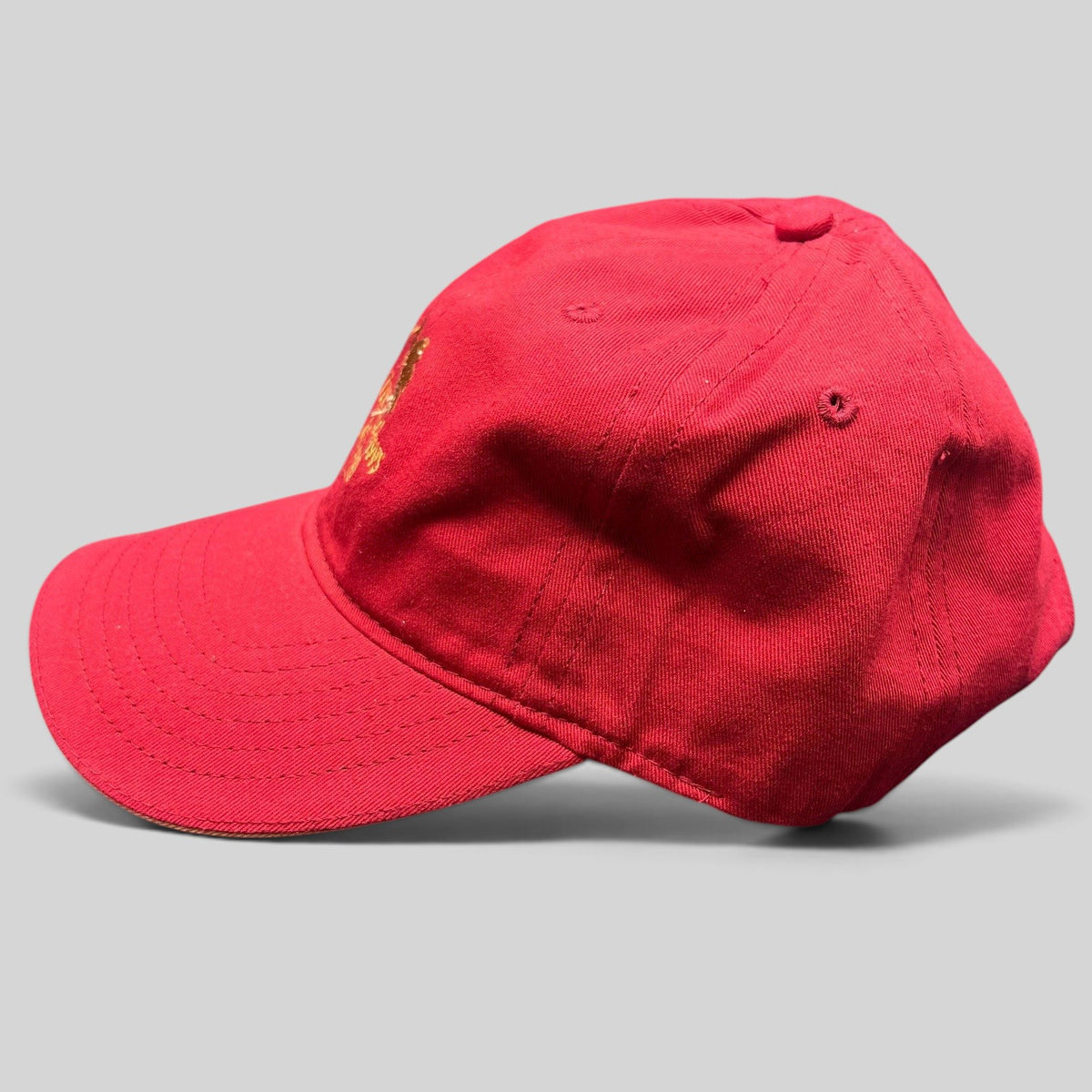Raree Finds red cotton twill strapback golf cap featuring The Meadows Del Mar embroidered golden flower logo