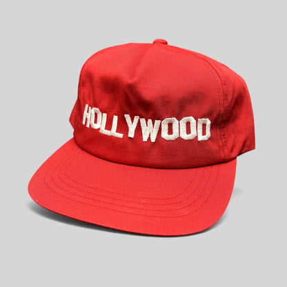 Raree Finds retro red Yupoong snapback hat with white HOLLYWOOD embroidery and a structured flat brim design.