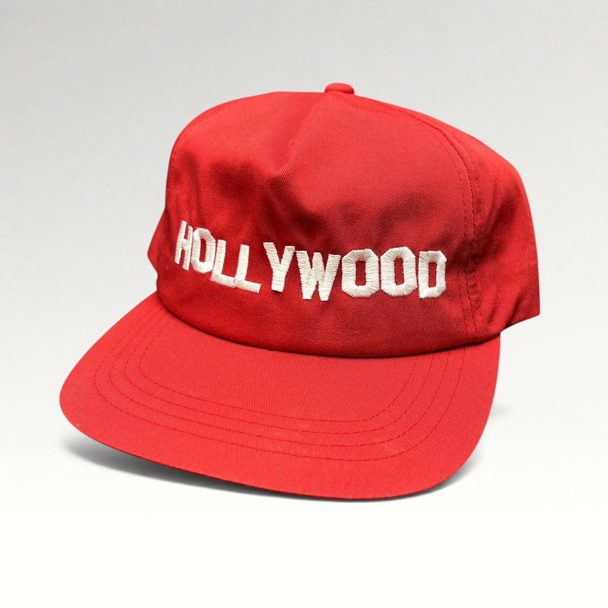 Raree Finds retro red Yupoong snapback hat with white HOLLYWOOD embroidery and a structured flat brim design.