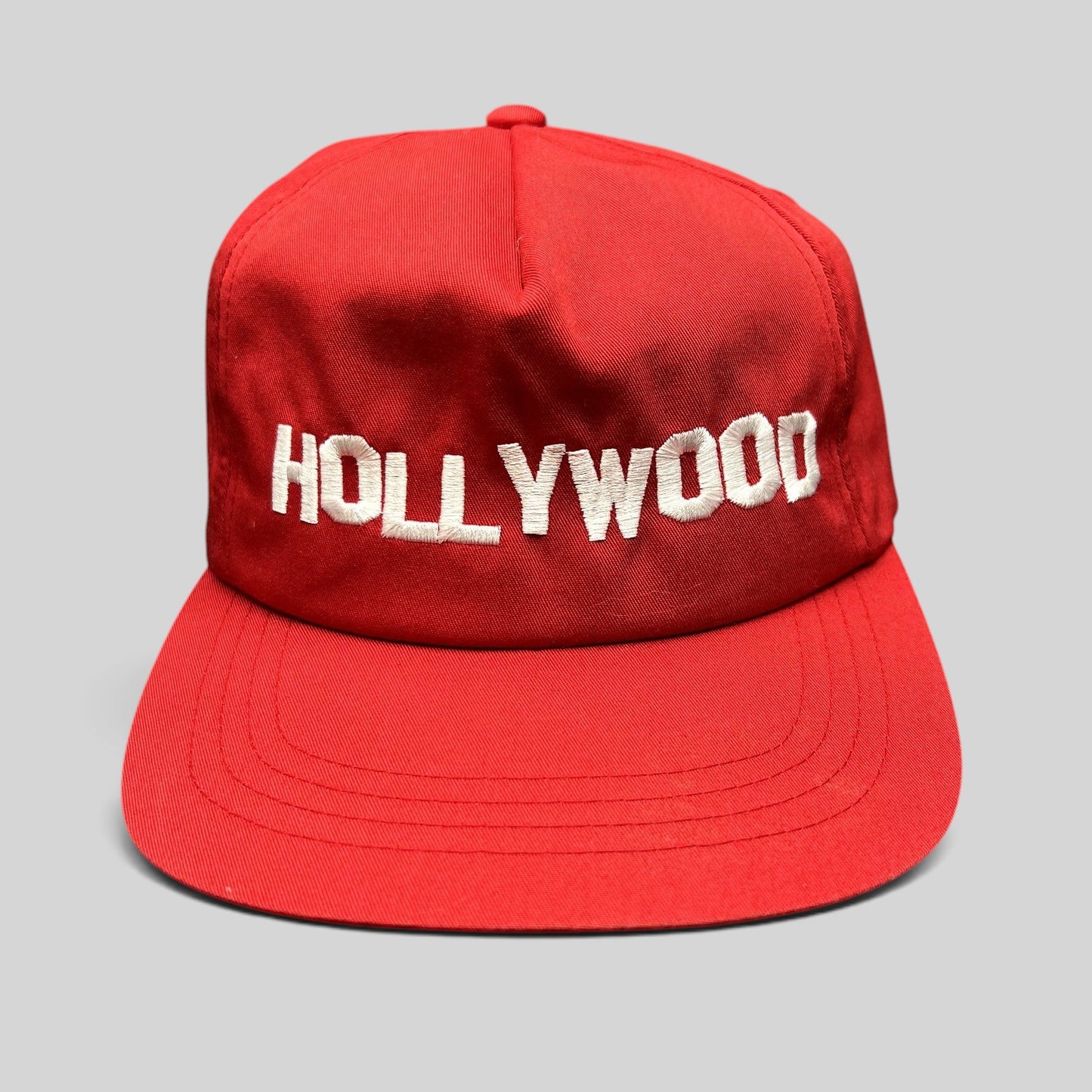 Raree Finds retro red snapback hat with white HOLLYWOOD embroidery on a structured crown and flat brim