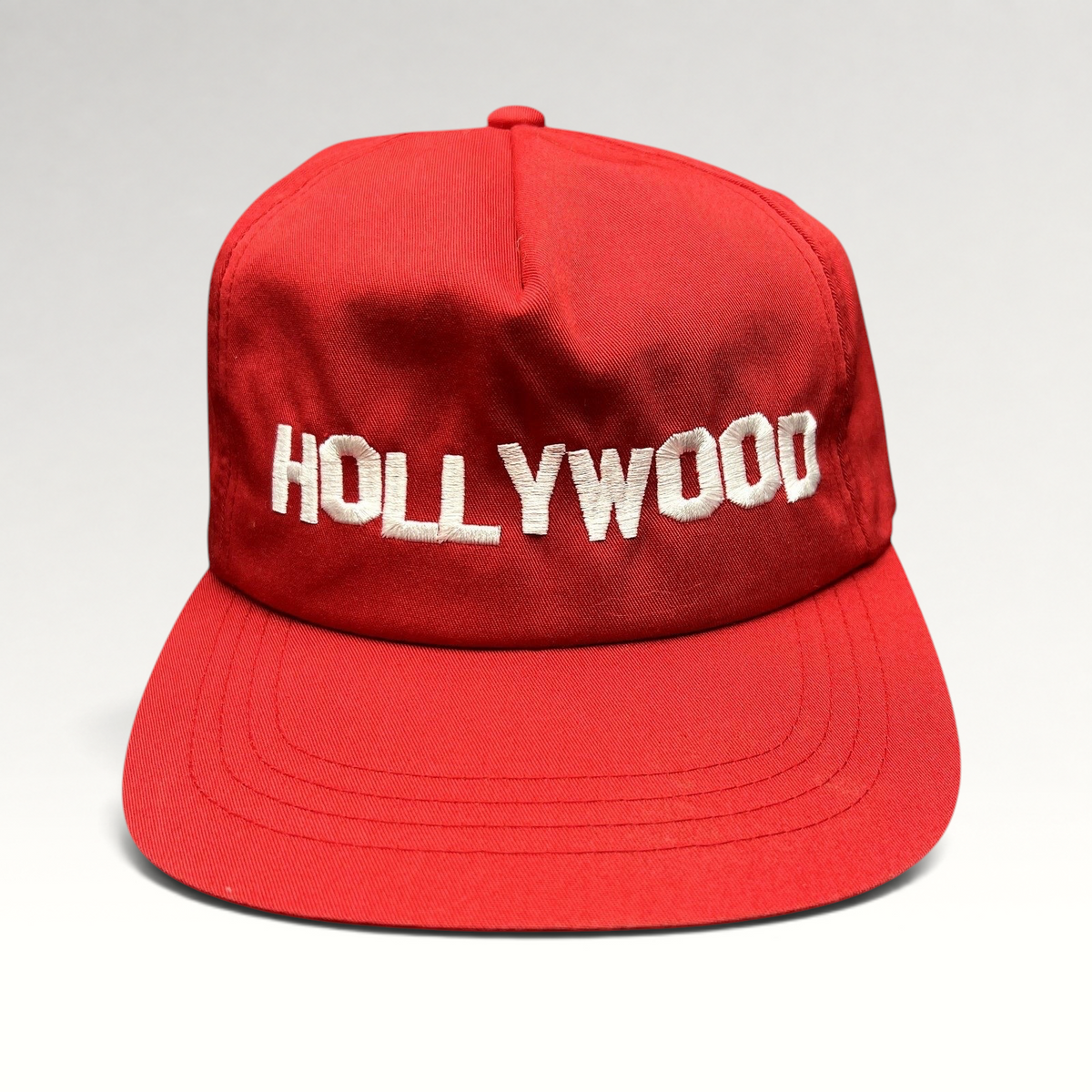 Raree Finds retro red snapback hat with white HOLLYWOOD embroidery on a structured crown and flat brim