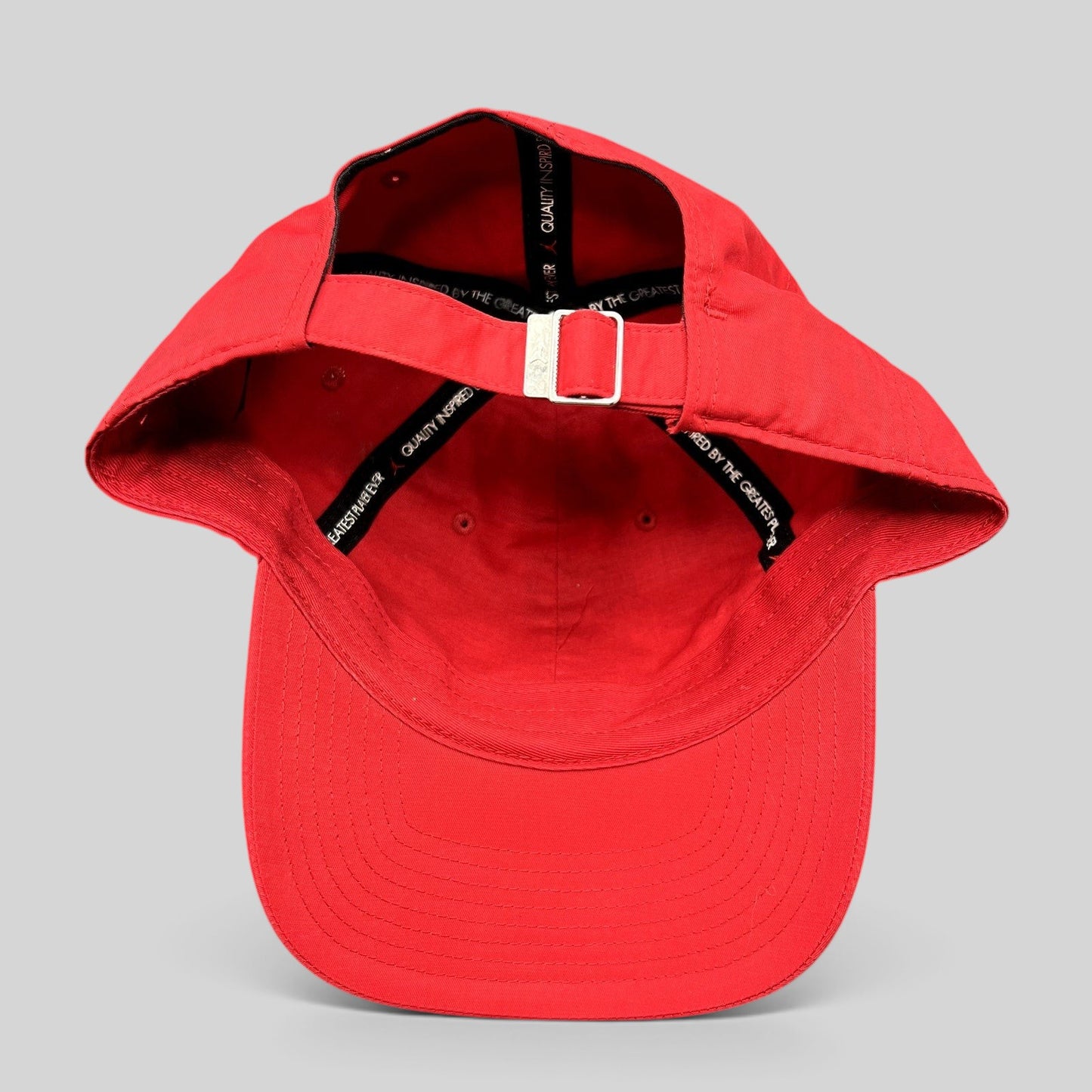 Raree Finds Nike Air Jordan red strapback club cap showing the interior adjustable metal buckle and branded taping.