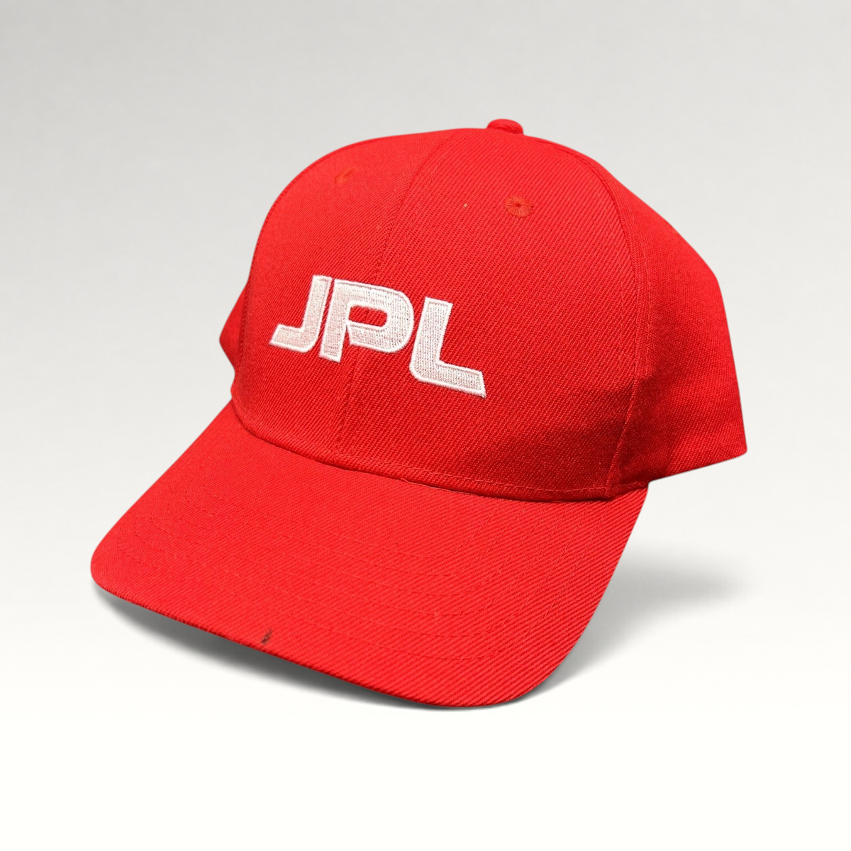 Raree Finds red JPL snapback hat with white embroidered logo on the front crown against a neutral background