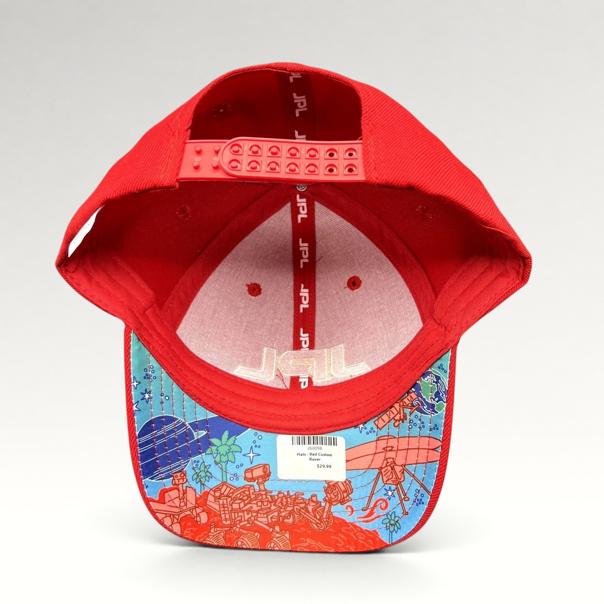 Raree Finds red JPL snapback hat with space-themed illustrated underbrim showing rovers and planets
