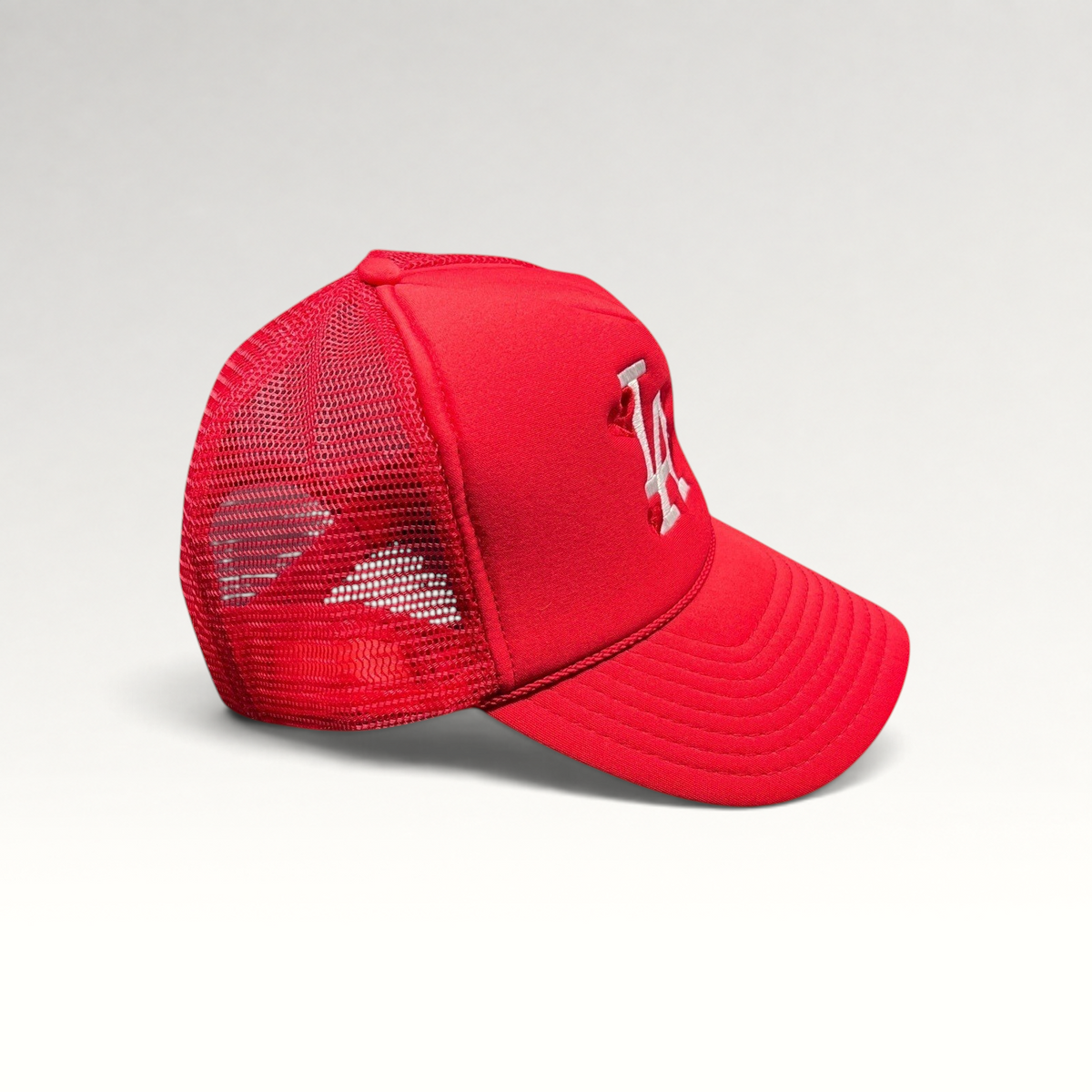 Raree Finds red Nissin Cap trucker hat with white embroidered LA logo and heart motifs on a foam front mesh back