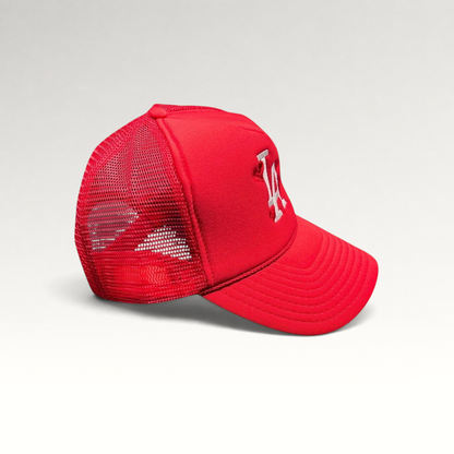 Raree Finds red Nissin Cap trucker hat with white embroidered LA logo and heart motifs on a foam front mesh back