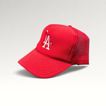 Raree Finds red Nissin Cap trucker hat with white embroidered LA logo and heart detail on a foam front mesh back