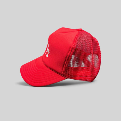 Raree Finds red Nissin Cap trucker hat with foam front, mesh back, and embroidered LA heart logo on a curved bill.