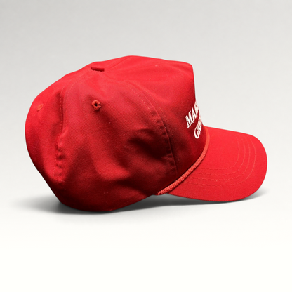 Raree Finds official red MAGA snapback hat with white embroidery and braided rope detail on a black background