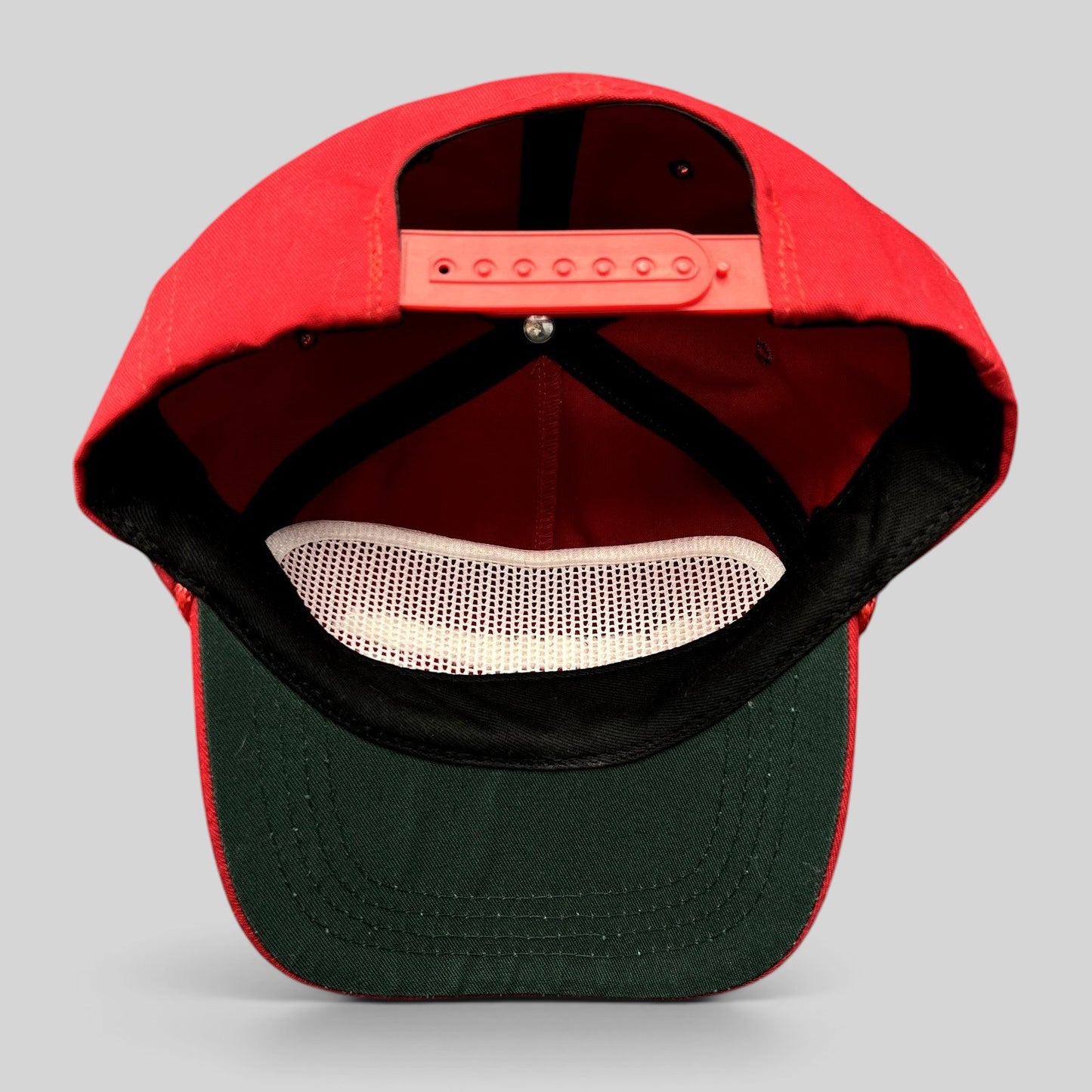 Raree Finds official red MAGA snapback hat with green undervisor and adjustable strap, interior view