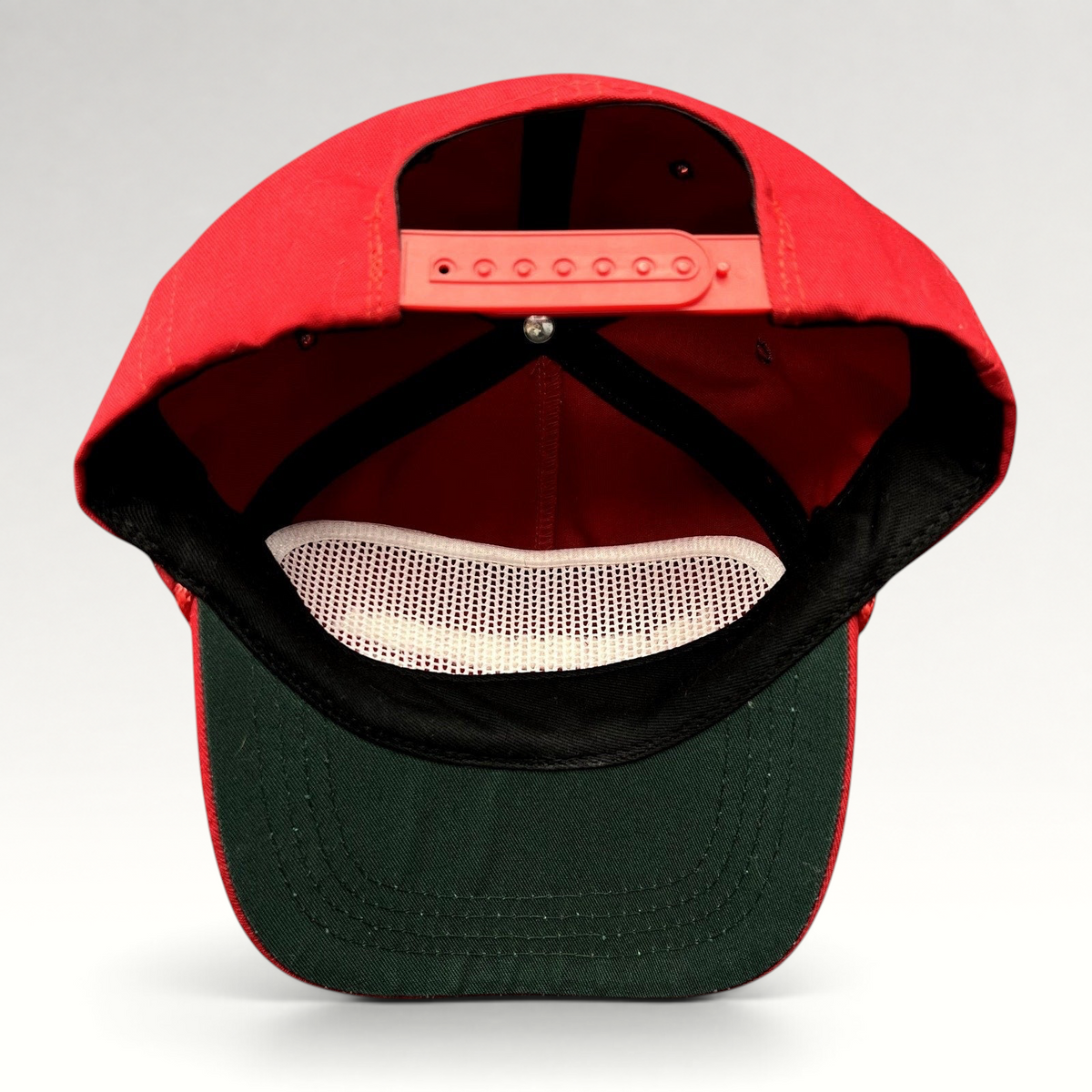 Raree Finds official red MAGA snapback hat with green undervisor and adjustable strap, interior view