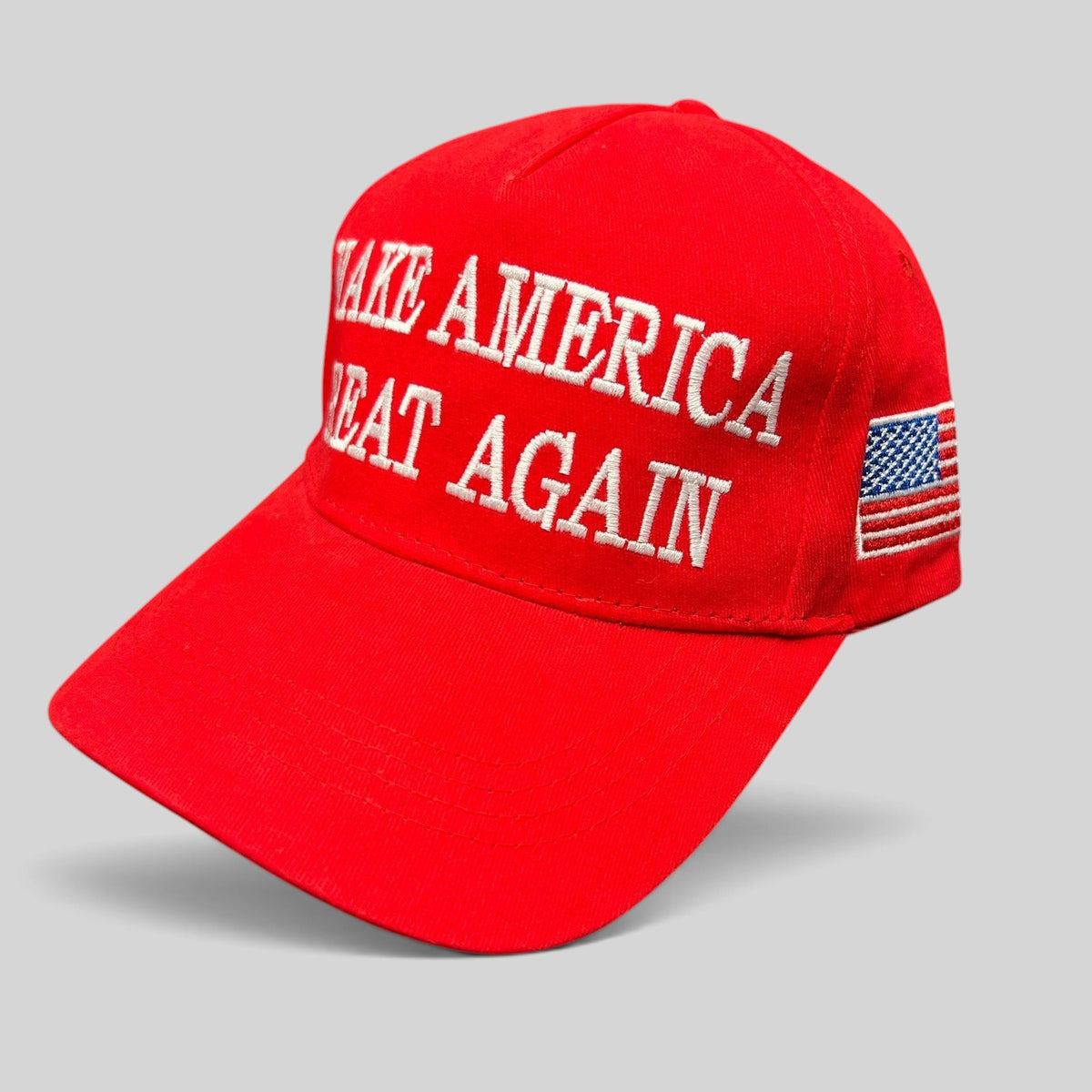 Raree Finds red strapback hat with white Make America Great Again embroidery and a small American flag on the side.