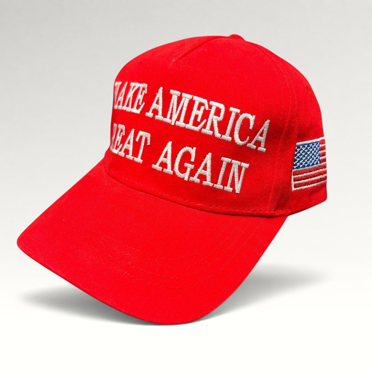 Raree Finds red strapback hat with white Make America Great Again embroidery and a small American flag on the side.