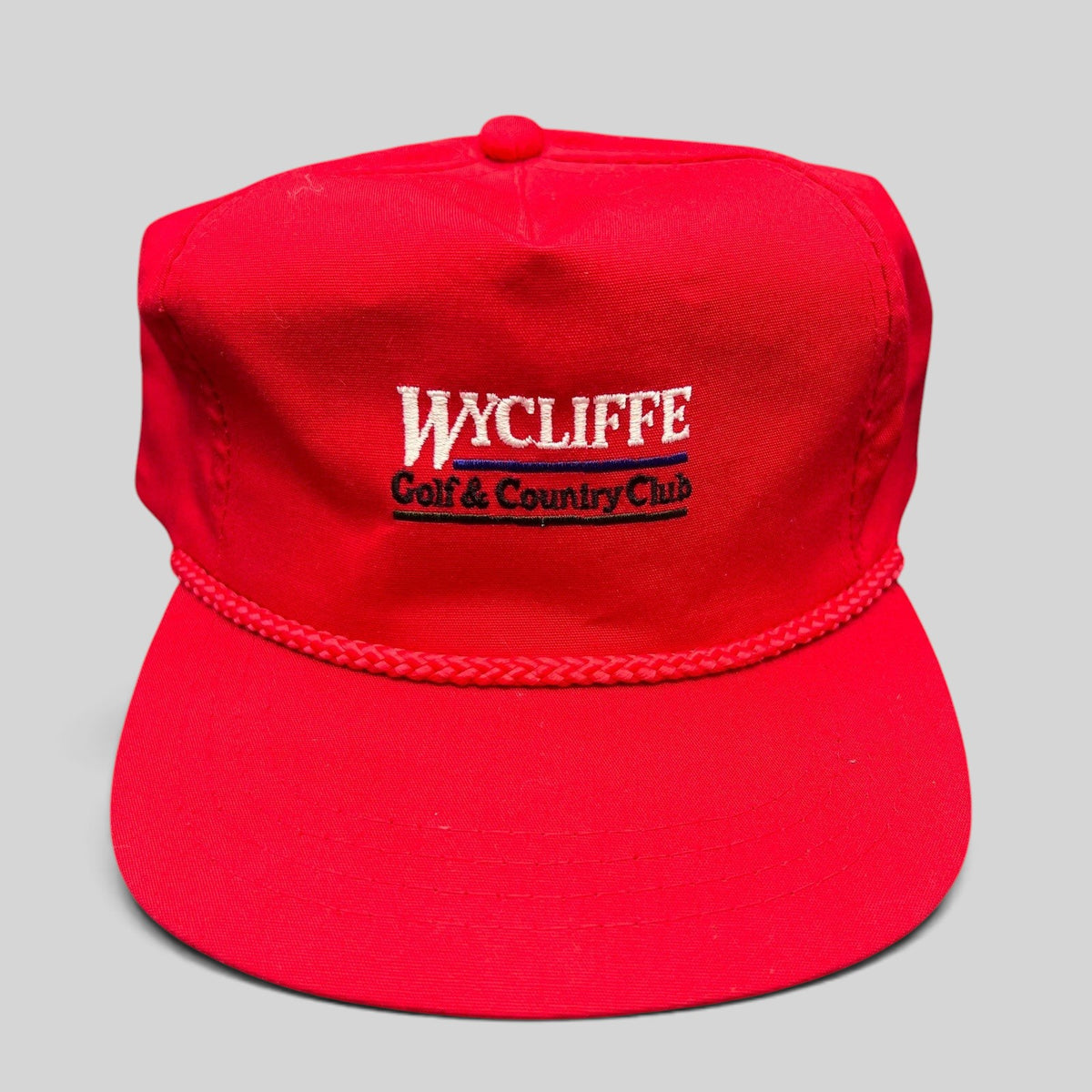 Raree Finds vintage red snapback hat with Wycliffe Golf & Country Club embroidery and decorative rope trim.