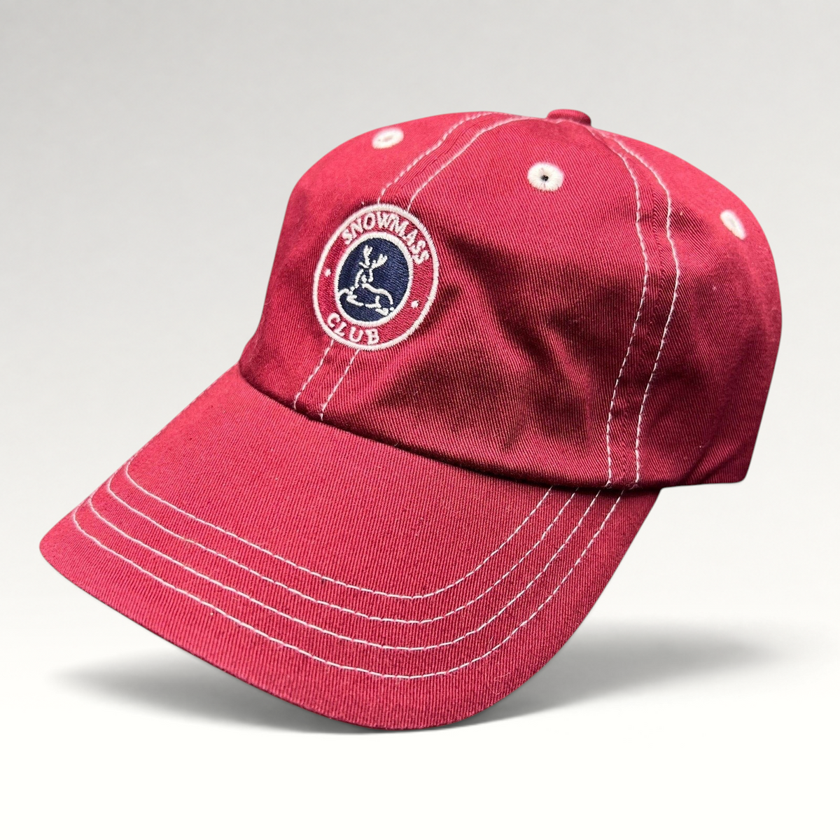 Raree Finds red Imperial strapback hat featuring the embroidered Snowmass Club deer crest and white contrast stitching.